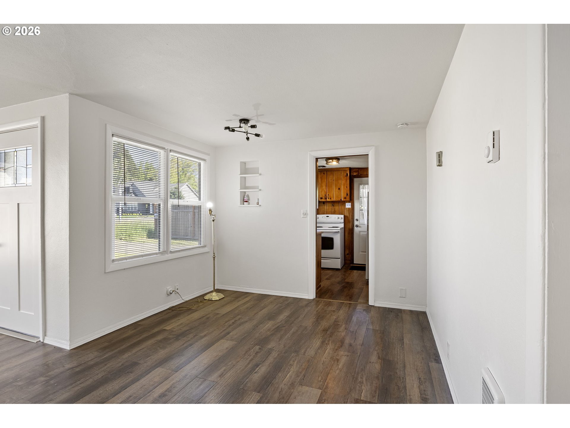 1008 Coburg Road Eugene, OR 97401 - Photo 7 of 46 a view of an empty room with wooden floor and a window