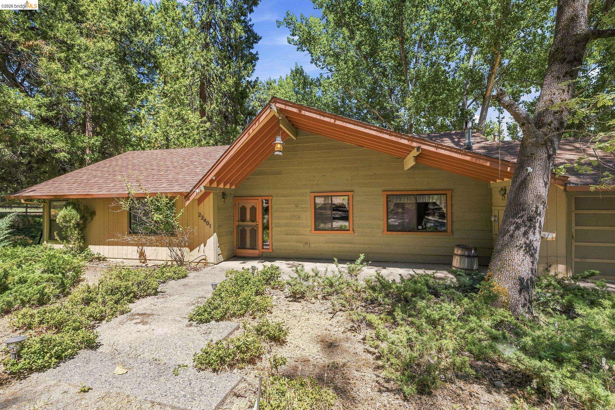 22401 South Fork Road Sonora, CA 95370 - Photo 2 of 34 Exterior featuring a gabled roof, horizontal siding, and a prominent front entry with a screen door