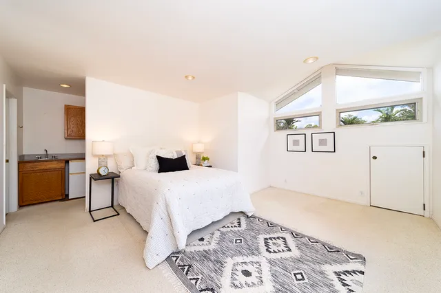 a bedroom with a bed and a cabinets