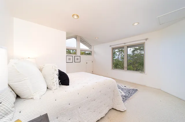 a bedroom with a large bed and a large window