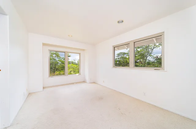 an empty room with windows and with yard