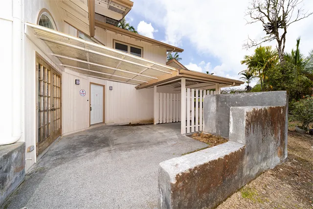 a view of a house with a wooden fence