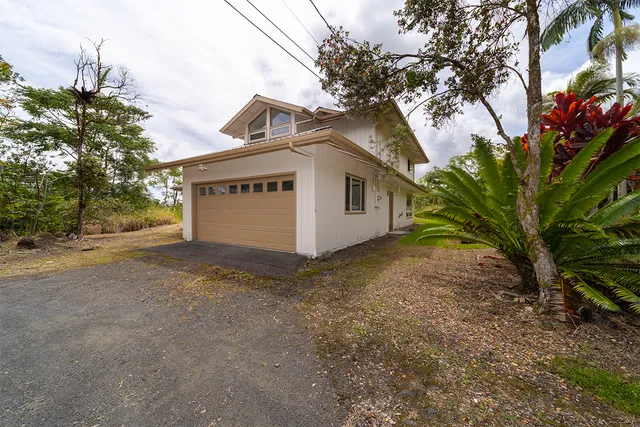 a view of a house with a tree in the background