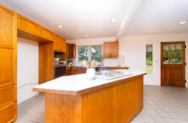 a kitchen with stainless steel appliances granite countertop a sink a stove and a refrigerator