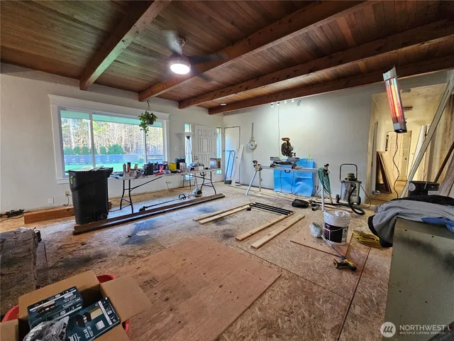 a living room with furniture gym equipment and a large window