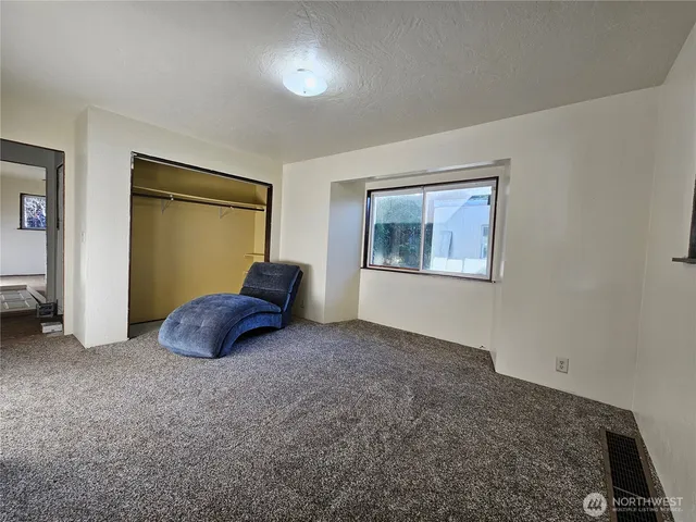 a bed room with a bed and a window