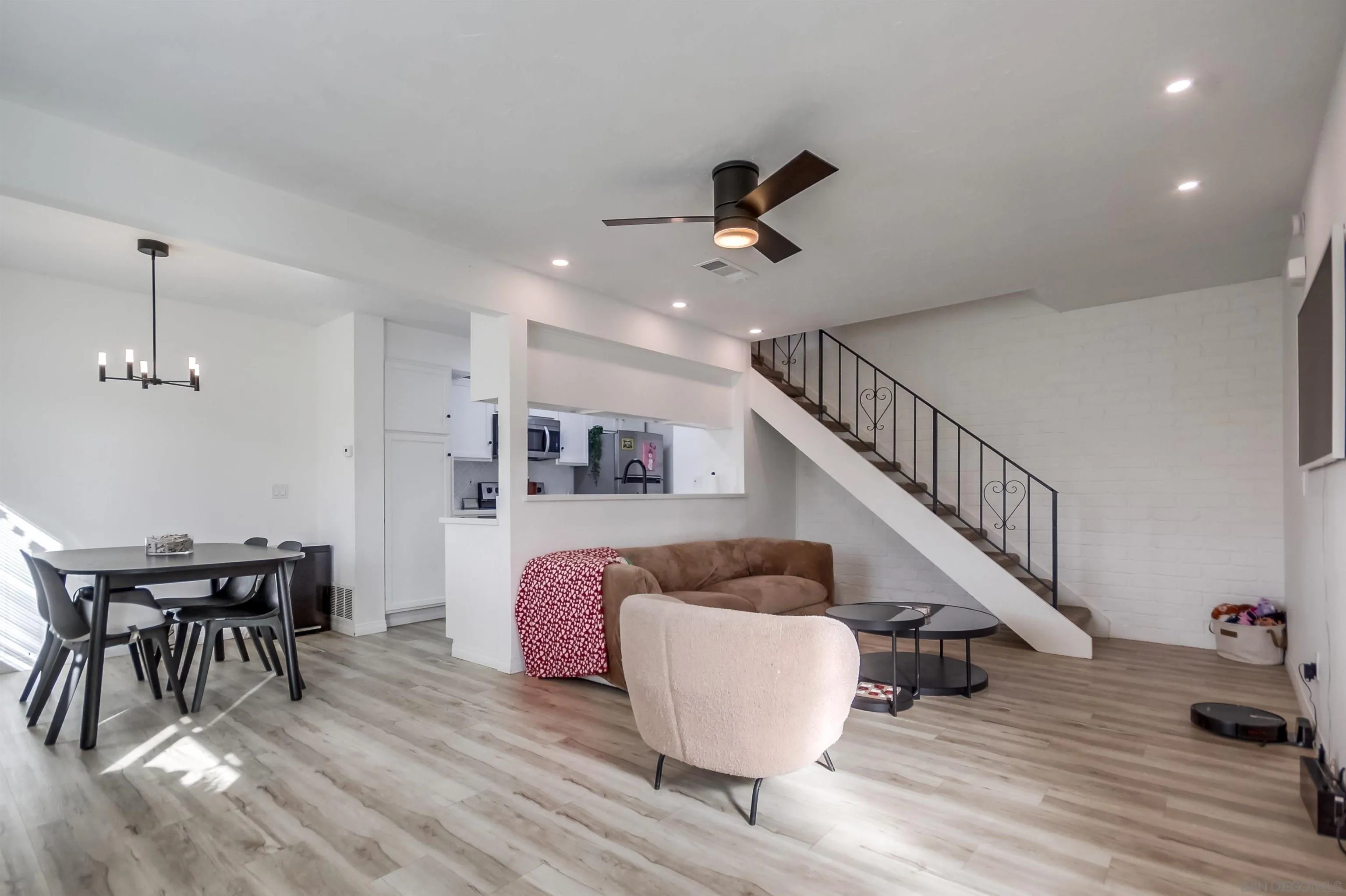 12100 Wintergreen Drive, Unit 3 Lakeside, CA 92040 - Photo 3 of 32 a living room with furniture and a dining table with wooden floor
