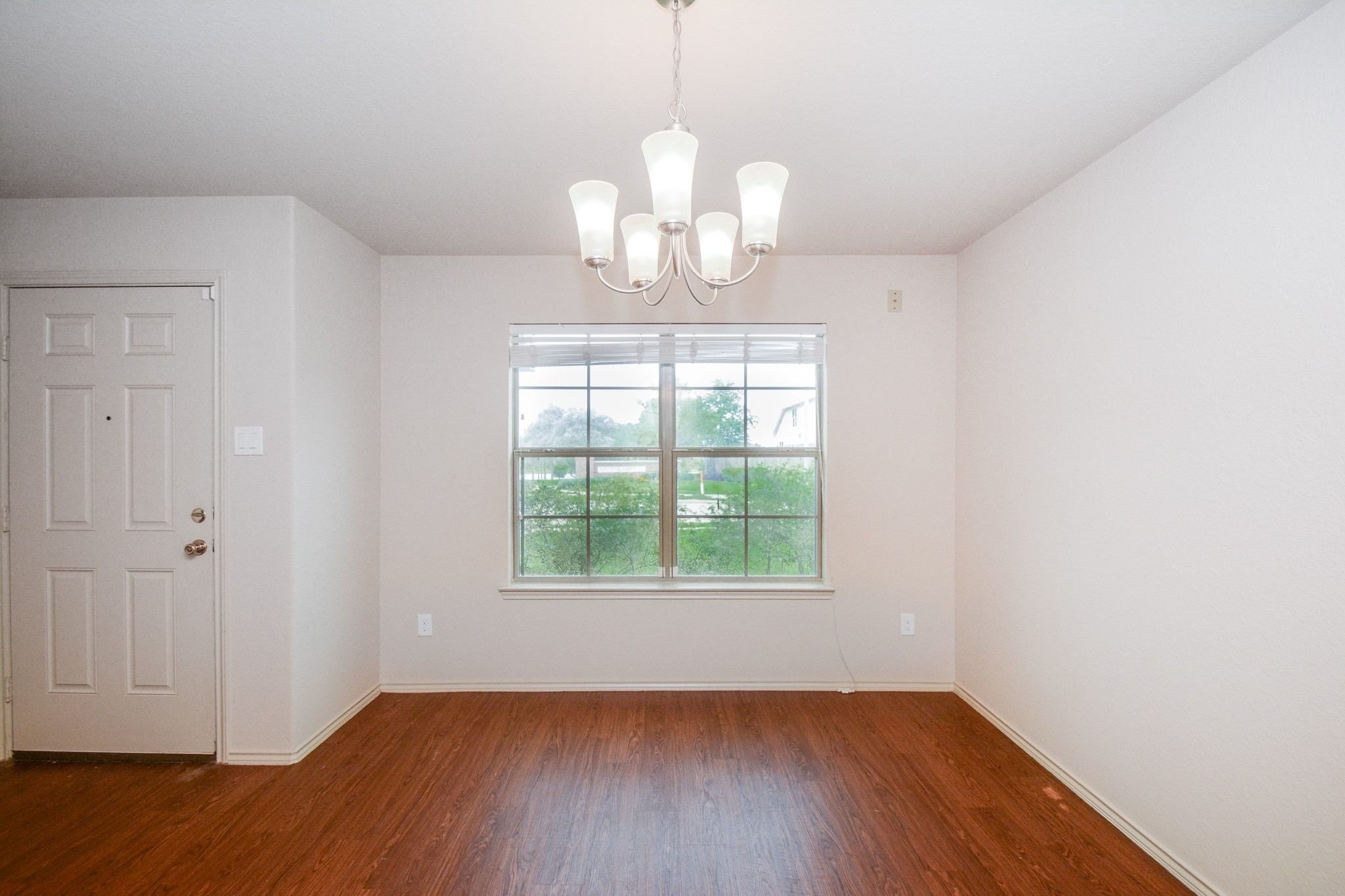 2003 Treasure Mountain Drive Spring, TX 77388 - Photo 12 of 20 a view of an empty room with wooden floor and a window