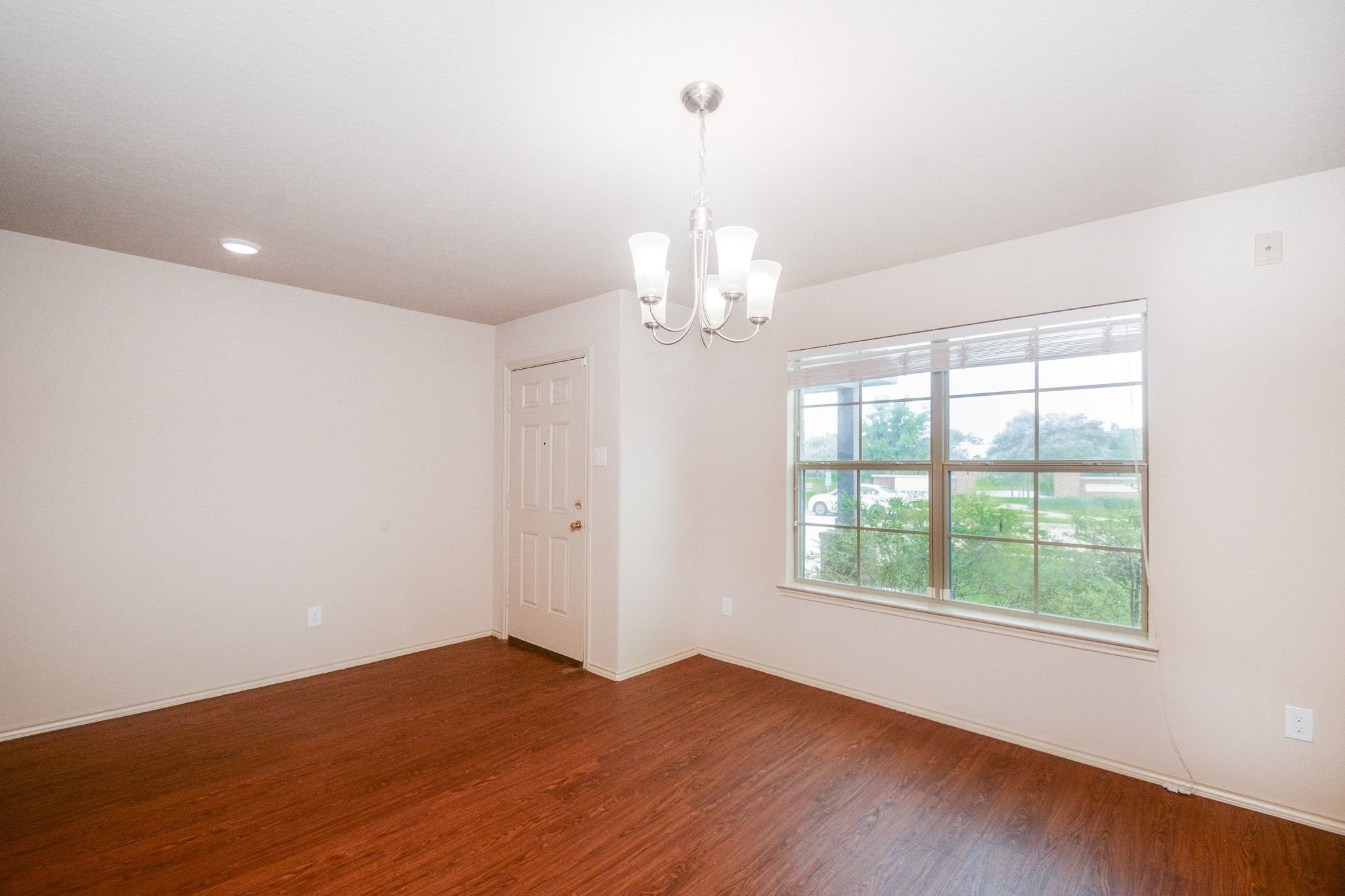 2003 Treasure Mountain Drive Spring, TX 77388 - Photo 14 of 20 an empty room with wooden floor and windows