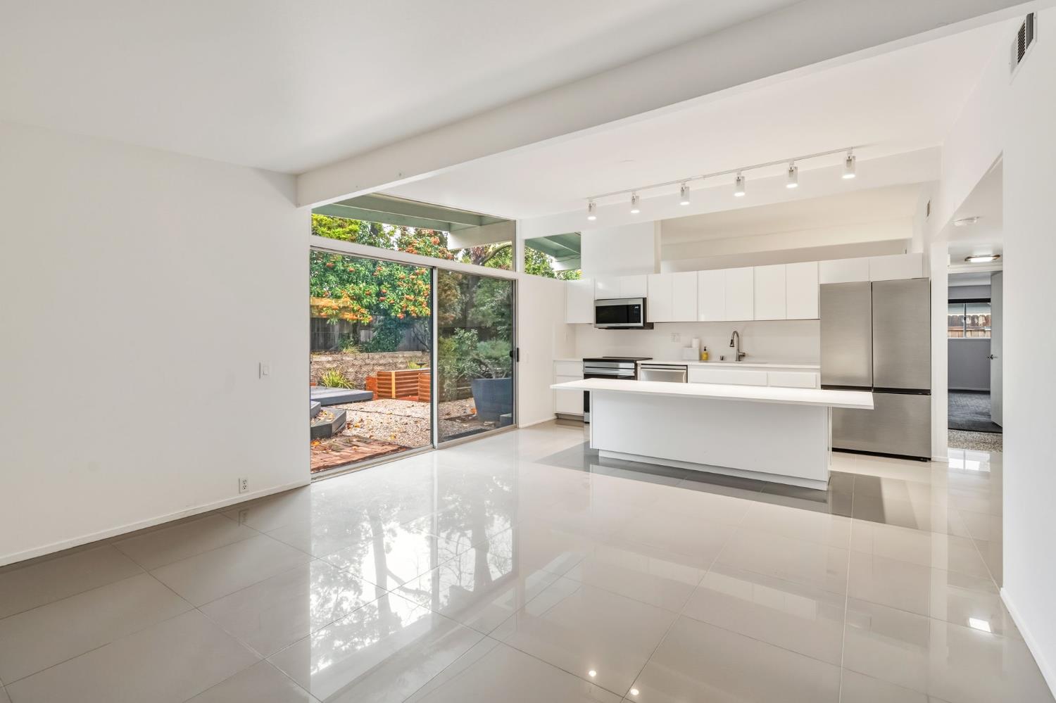 5229 Overbrook Way Sacramento, CA 95841 - Photo 10 of 28 a large white kitchen with cabinets a sink and a large window