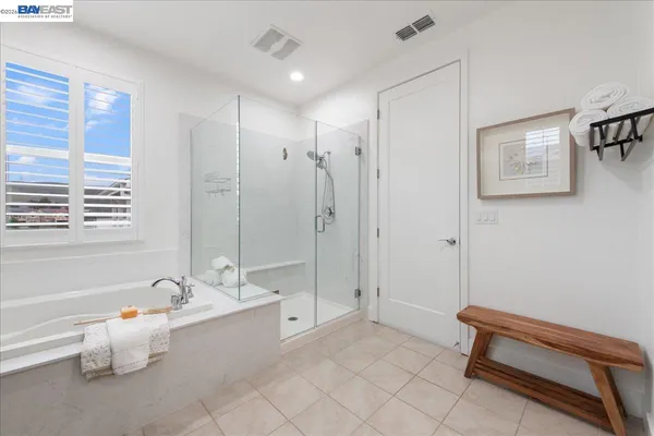 a spacious bathroom with a tub shower and sink