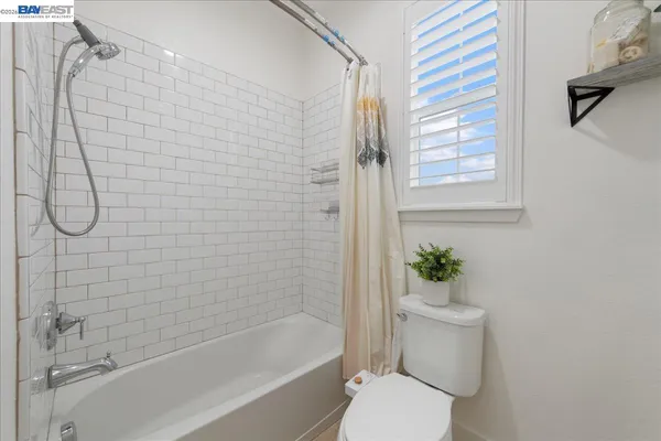 a bathroom with a shower a toilet and a shower