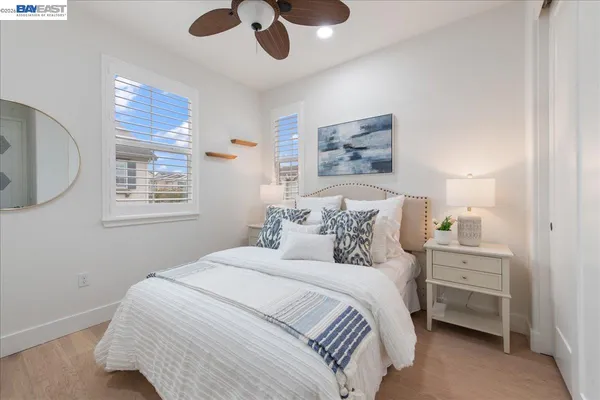 a bedroom with a bed and a painting on the wall