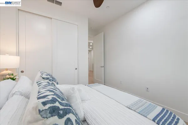 a bedroom with a bed and a couch