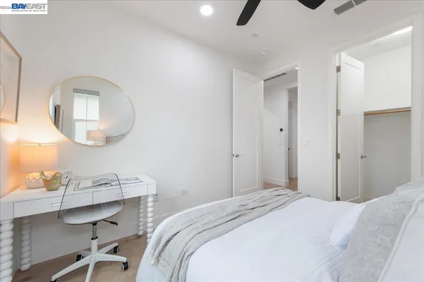 a bedroom with a bed and chandelier