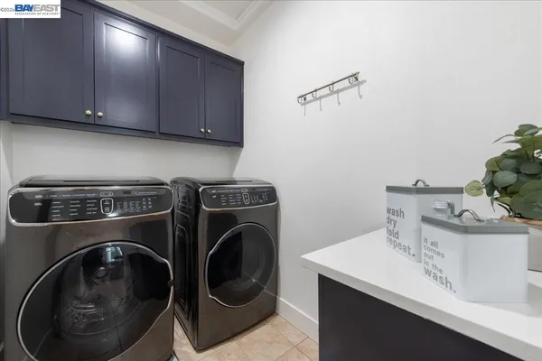 a utility room with sink dryer and washer