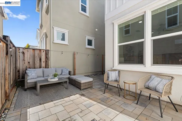 a view of two chairs in a patio