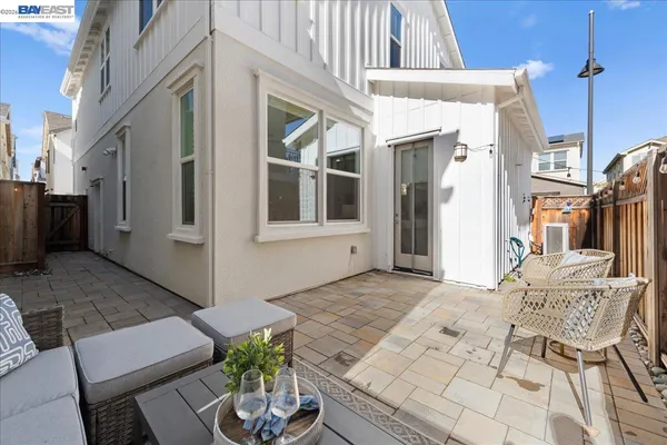 a view of a patio with a dining table and chairs
