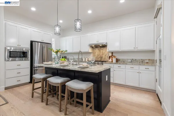 a kitchen with granite countertop appliances cabinets and furniture