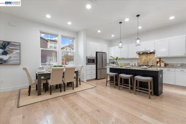 a large kitchen with a table and chairs