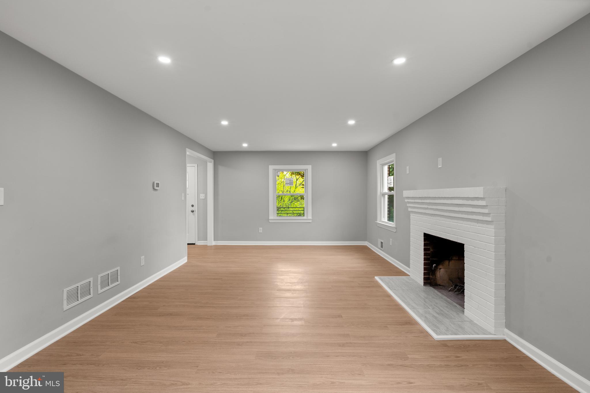 7946 Max Blobs Park Road Hanover, MD 21076 - Photo 6 of 47 Large living room with a cozy fireplace