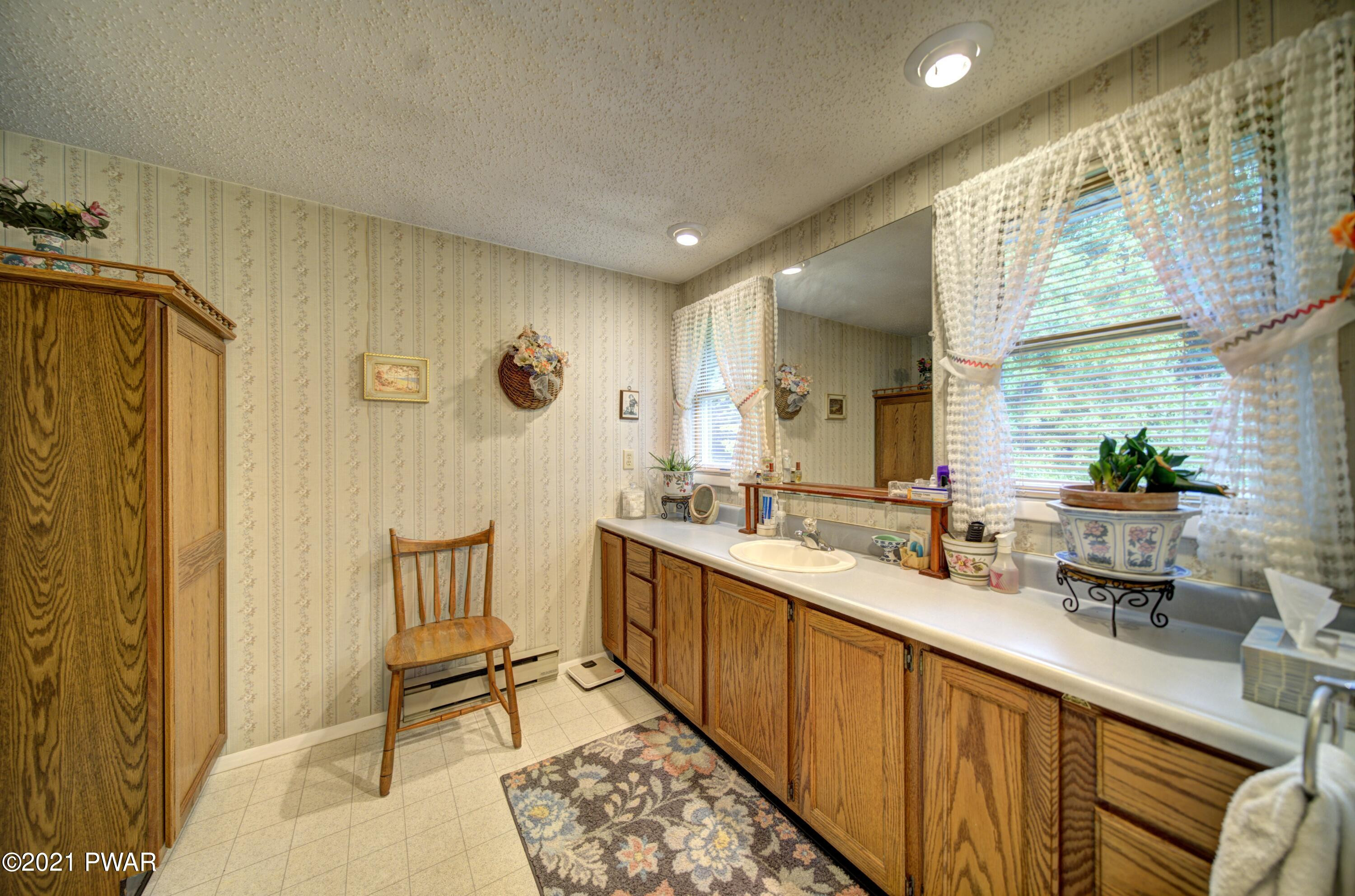 368 Roemerville Road Greentown, PA 18426 - Photo 42 of 59 a spacious bathroom with a double vanity sink a mirror and a bathtub