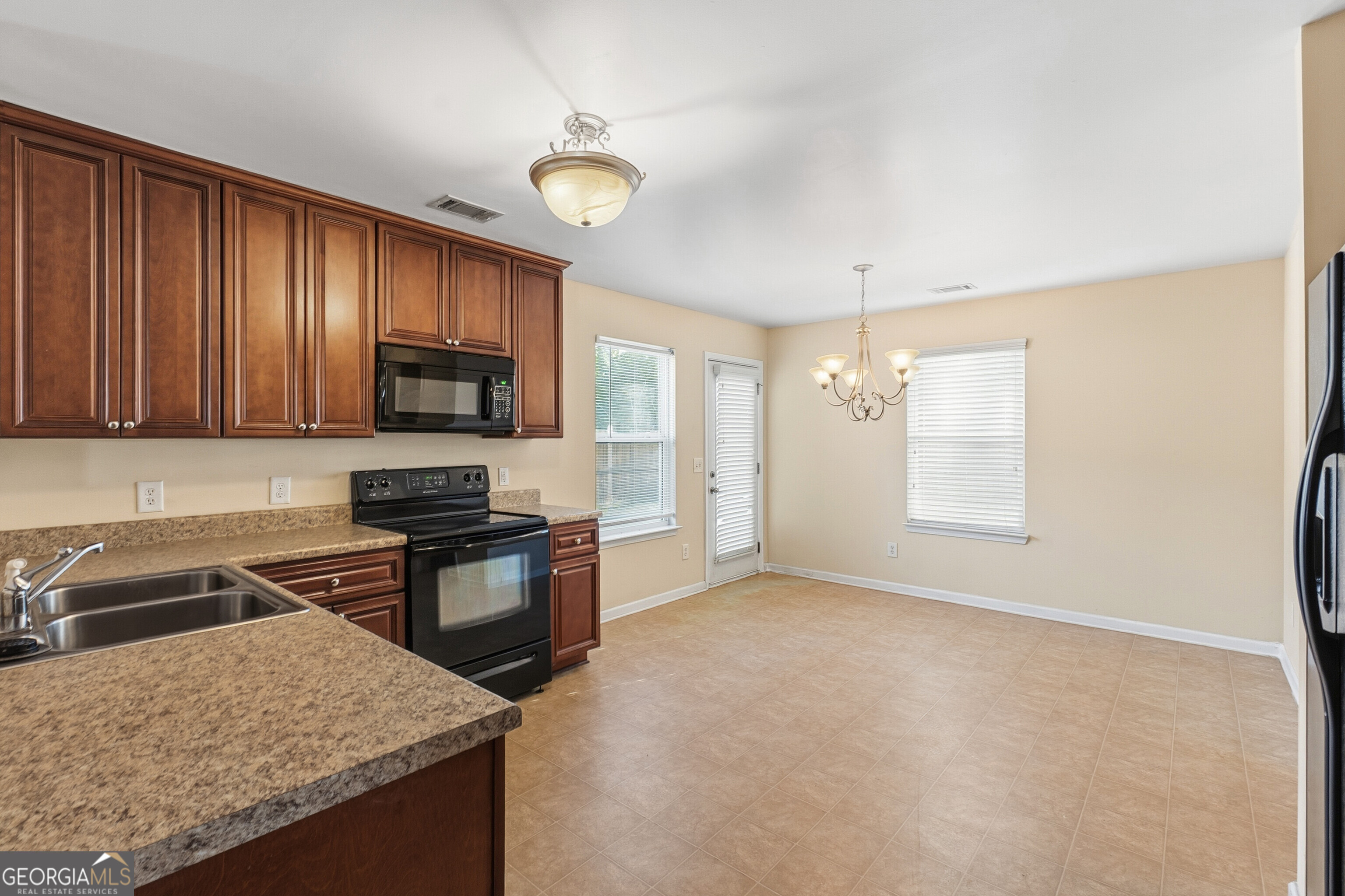 102 Steeple Court Perry, GA 31069 - Photo 9 of 37 a kitchen with stainless steel appliances granite countertop a sink stove and refrigerator