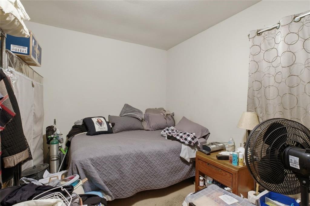913 Old Noonday Sch House Road Marietta, GA 30066 - Photo 12 of 42 a bedroom with a bed and a flat tv screen on the dresser