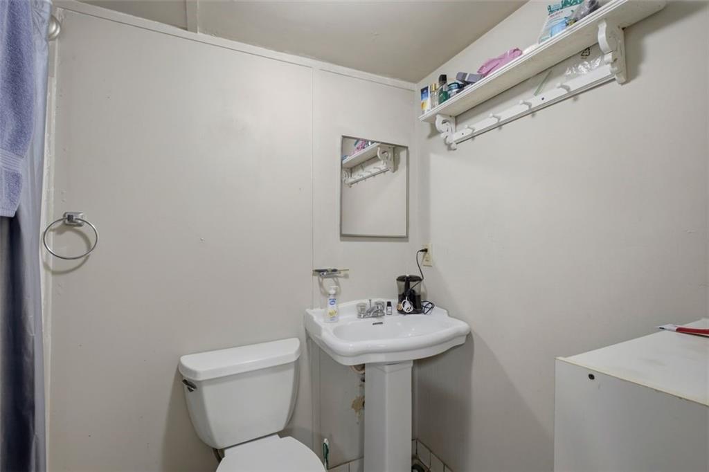 913 Old Noonday Sch House Road Marietta, GA 30066 - Photo 16 of 42 a bathroom with a toilet sink and mirror