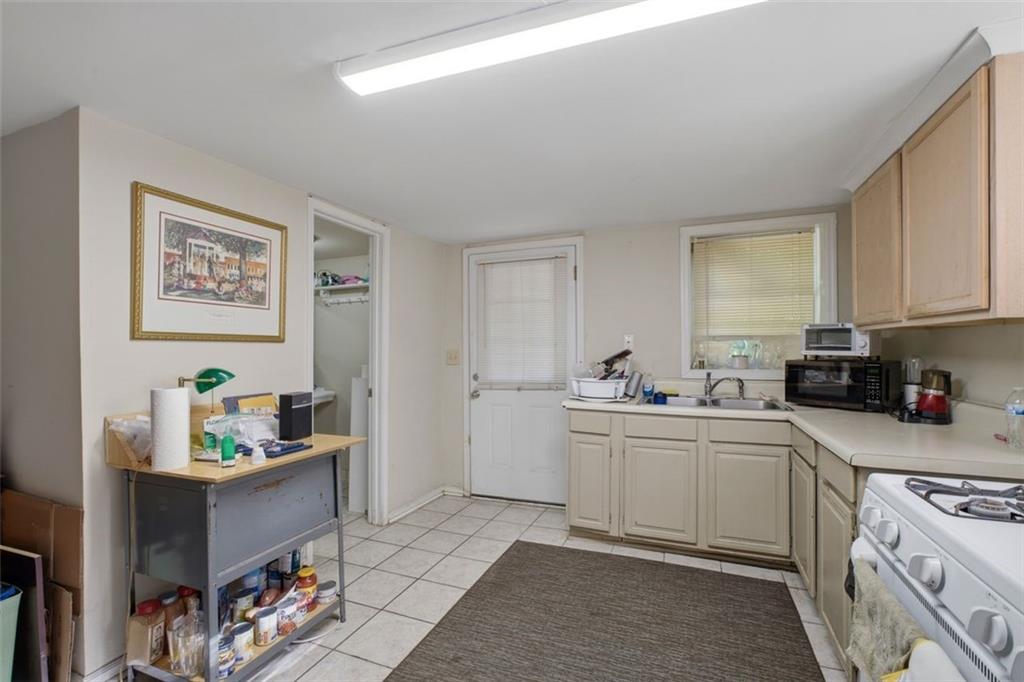 913 Old Noonday Sch House Road Marietta, GA 30066 - Photo 17 of 42 a kitchen with a sink cabinets and wooden floor