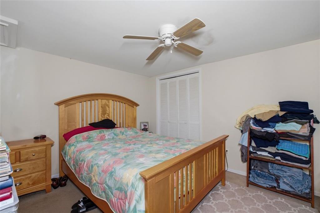 913 Old Noonday Sch House Road Marietta, GA 30066 - Photo 19 of 42 a bedroom with a bed and a chandelier