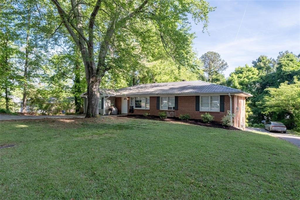 913 Old Noonday Sch House Road Marietta, GA 30066 - Photo 2 of 42 a front view of a house with a garden