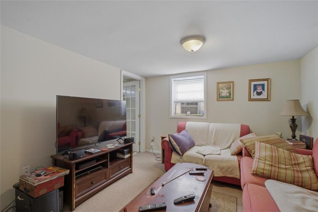 913 Old Noonday Sch House Road Marietta, GA 30066 - Photo 21 of 42 a living room with furniture and a flat screen tv