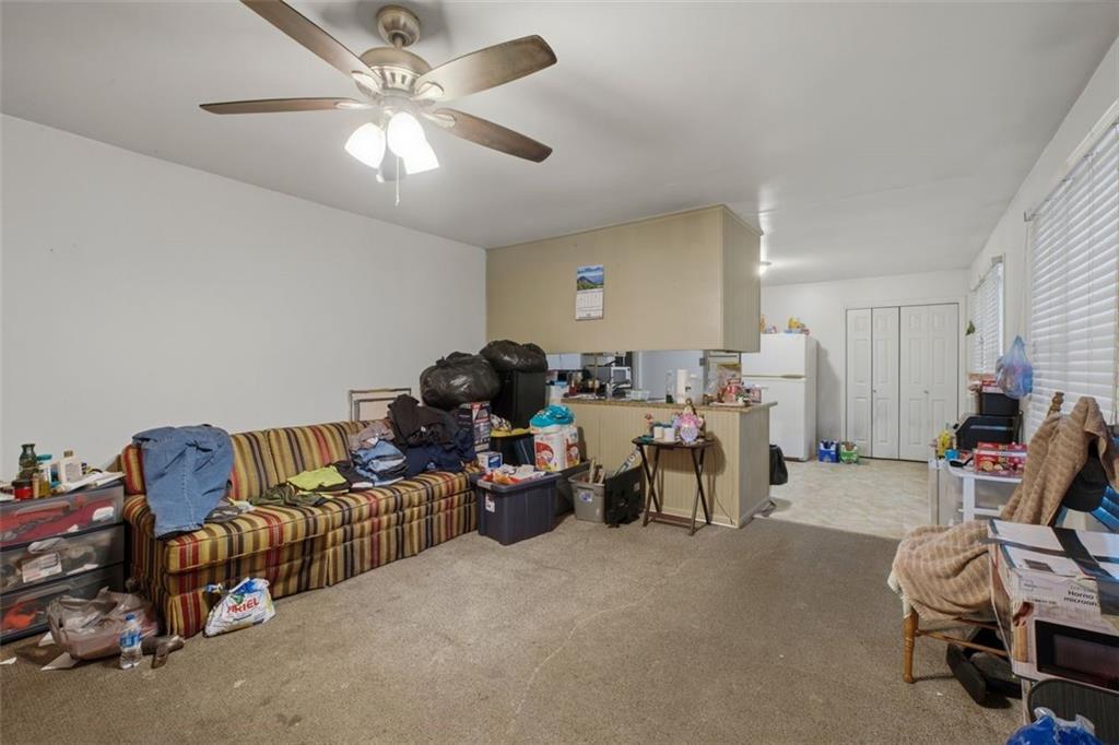 913 Old Noonday Sch House Road Marietta, GA 30066 - Photo 29 of 42 a living room with furniture and a chandelier