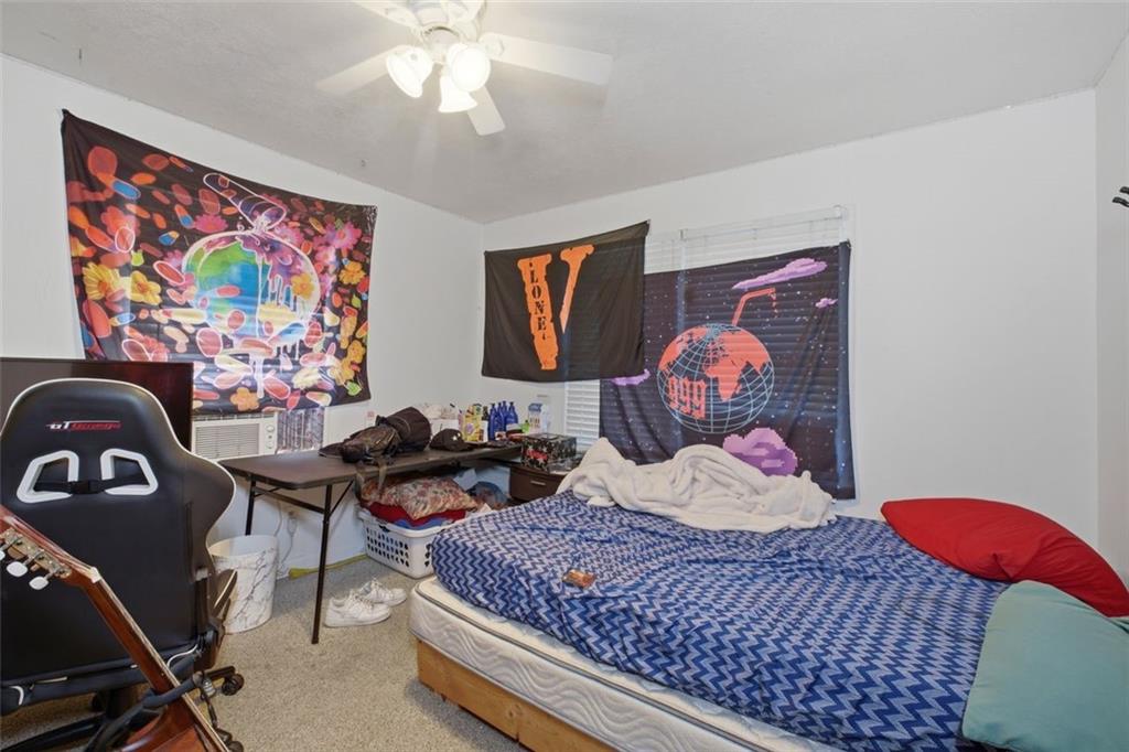 913 Old Noonday Sch House Road Marietta, GA 30066 - Photo 35 of 42 a bedroom with a bed and wooden floor