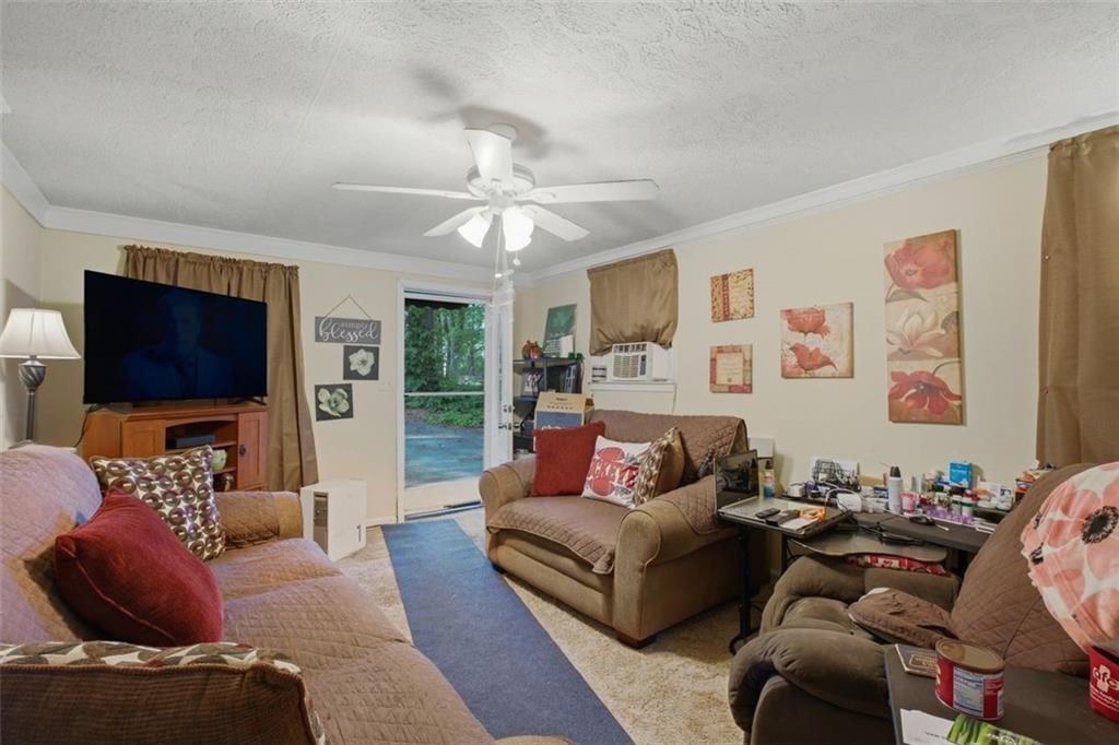 913 Old Noonday Sch House Road Marietta, GA 30066 - Photo 6 of 42 a living room with furniture workspace and a flat screen tv