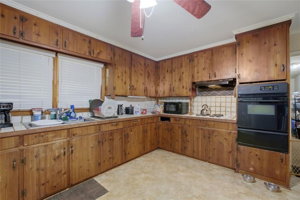 913 Old Noonday Sch House Road Marietta, GA 30066 - Photo 8 of 42 a kitchen with sink cabinets and microwave