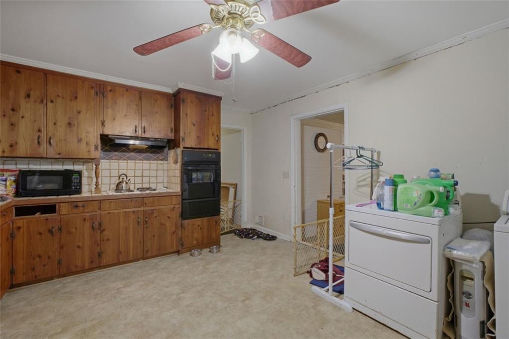 913 Old Noonday Sch House Road Marietta, GA 30066 - Photo 9 of 42 a kitchen that has a lot of cabinets and refrigerator in it