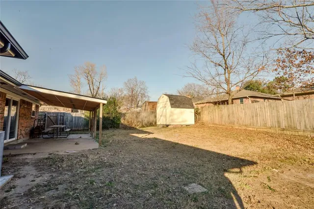 a view of a dirt road with a building