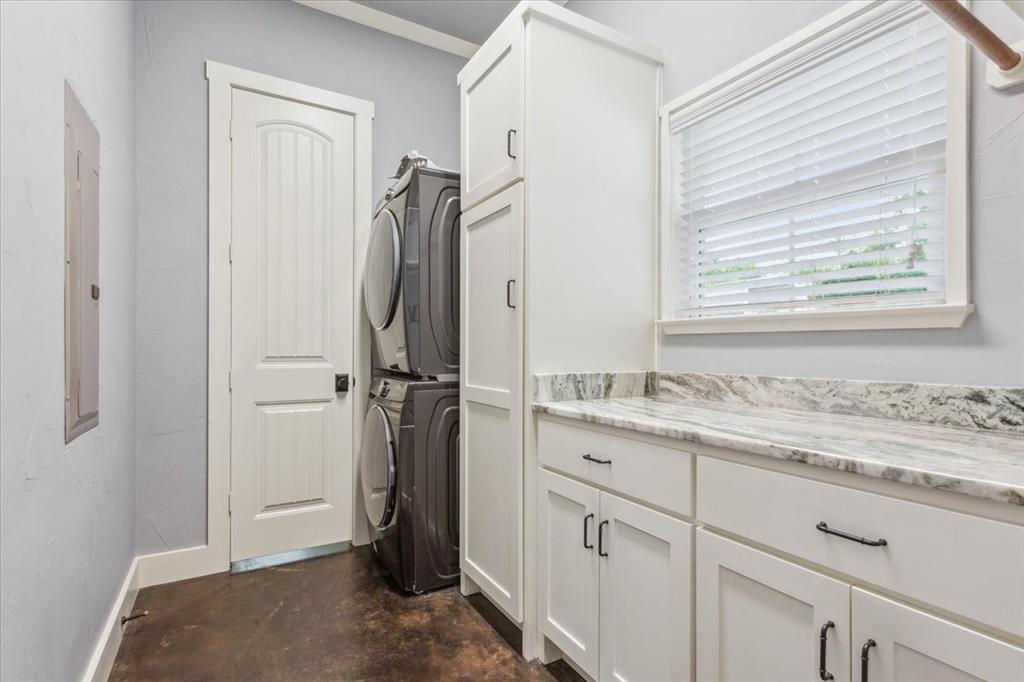 259 County Road 149 Riesel, TX 76682 - Photo 29 of 40 Laundry room with cabinet space, stacked washer / drying machine, and baseboards