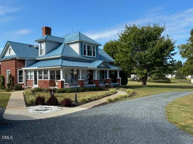 a view of a house with swimming pool and sitting area