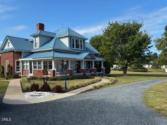 a view of a house with swimming pool and sitting area