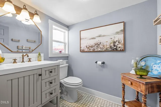 a bedroom with a bed and a flat tv screen on wall