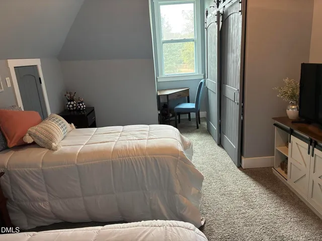 a living room with furniture a clock and a fireplace