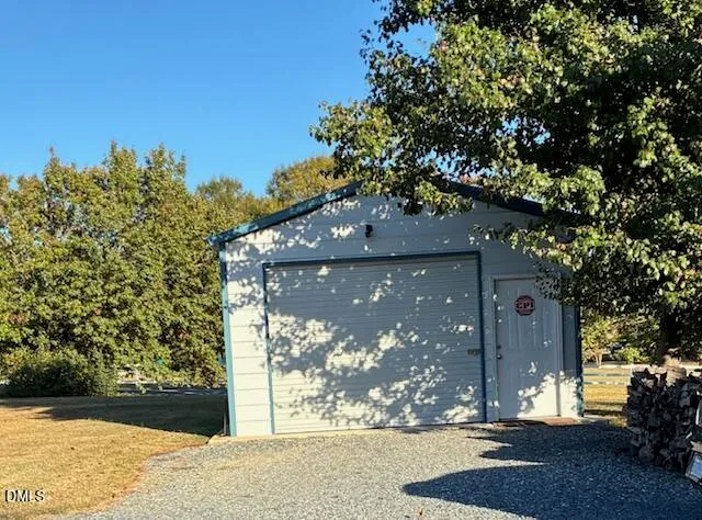 a bedroom with a bed and a flat tv screen on a dresser