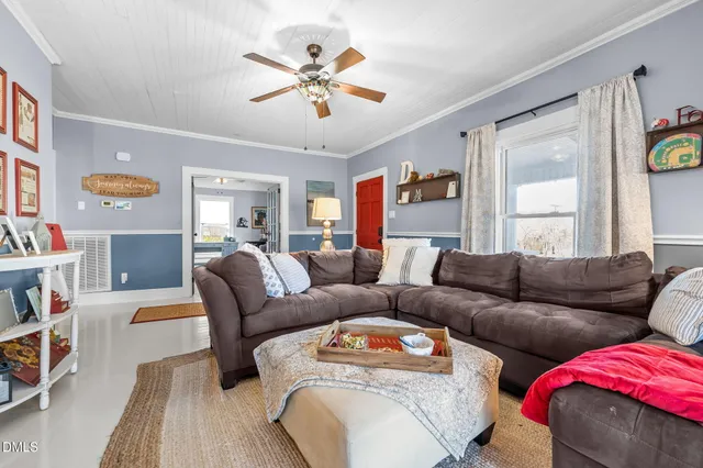 a living room with furniture and a book shelf