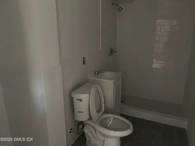 a white toilet sitting next to a small sink