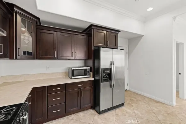 a kitchen with a refrigerator and cabinets