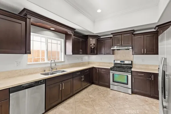a kitchen with a sink stove and cabinets