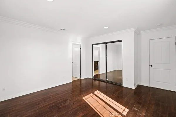 a living room with a couch and wooden floor